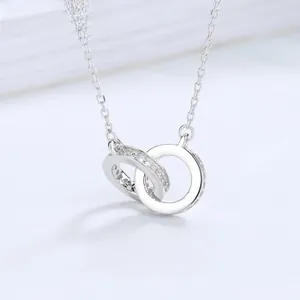 Macro detail of intertwined S925 silver rings with pavé cubic zirconia on fine link chain