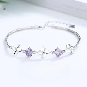 Close-up of 925 sterling silver four-leaf clover bracelet with purple zircon stones