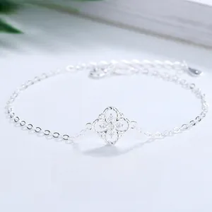 Close-up of S925 silver clover bracelet with inlaid white zircons and hollow design
