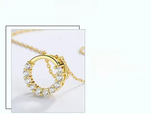 Macro detail of gold-plated silver ring pendant with sparkling claw-set crystals