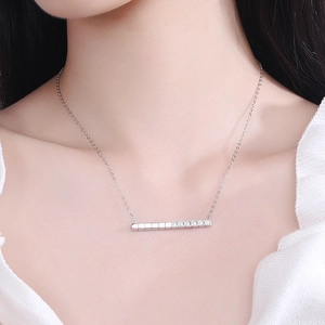 Elegant 925 sterling silver bar necklace with cubic zirconia on model's neckline