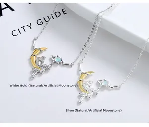Close-up of moonlight stone rabbit necklaces in gold and silver on a magazine