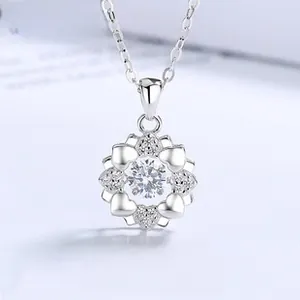 Macro detail of silver snowflake necklace pendant with large central sparkling zircon