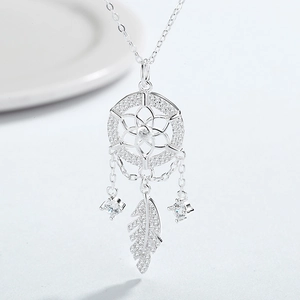 Macro detail of 925 sterling silver dreamcatcher pendant with leaf and zircon stones