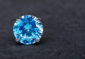 Close-up of 3A+ sky blue zircon stud earring with classic four-prong silver setting