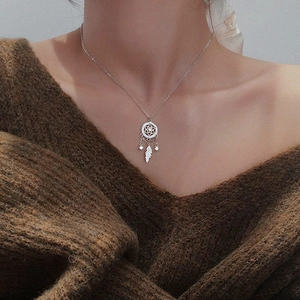 925 sterling silver dreamcatcher necklace with zircon feathers on a cozy knit sweater