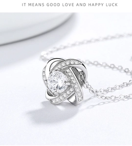Macro shot of 925 silver clover pendant with a large central zircon and pavé detailing