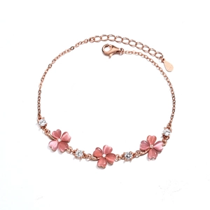 Detail of rose gold clover bracelet with pink opal inlays and S925 silver hallmark