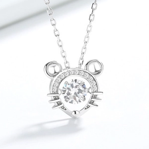 Macro shot of 925 sterling silver mouse pendant with dancing central zircon stone