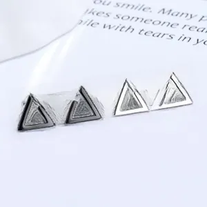 Minimalist geometric triangle stud earrings in polished black and silver finishes