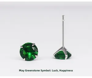 Detailed view of May birthstone silver studs with green zircon in four-claw setting