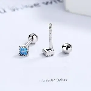 Macro detail of square blue zircon earrings in 925 silver with screw back design