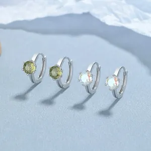 Close-up of 925 sterling silver hoop earrings with green zircon and white opal gemstones