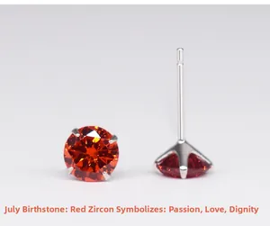 Detail of 925 silver stud earrings with four-prong set red zircon July birthstone