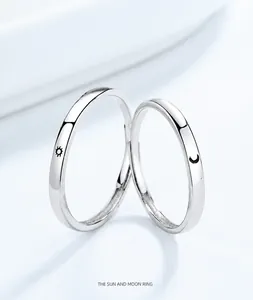 Detailed macro view of sun and moon couple rings in polished 925 sterling silver