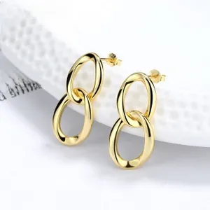 Detailed view of polished gold double oval linked earrings on a white stand