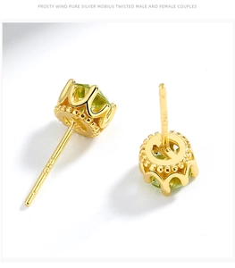 Macro view of S925 sterling silver crown stud earrings with green peridot stones