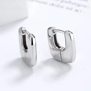 Macro detail of polished 925 silver interlocking geometric hoop earrings for women