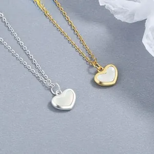 Detail of 925 silver heart necklaces in gold and silver finish with opal centers
