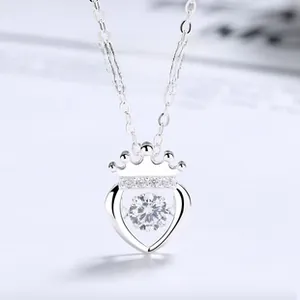 Macro detail of S925 sterling silver heart crown pendant with sparkling dancing stone