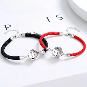 Detail of red and black woven couple bracelets with 925 silver hollow geometric beads