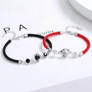 Detail of S925 silver Mobius bracelets with black and red braided rope and zircon stones