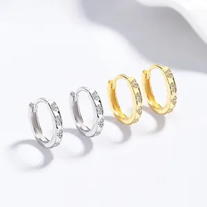 Detail of S925 silver hoop earrings in gold and silver finish with sparkling zircon stones