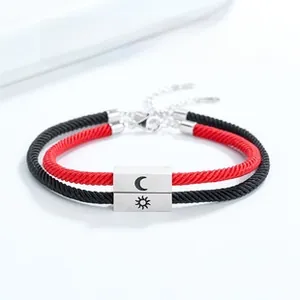 Detail of S925 silver sun and moon magnetic charms on woven couple bracelets