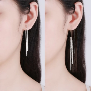 Detail of silver long tassel earrings with sparkling rhinestones in two wearing styles