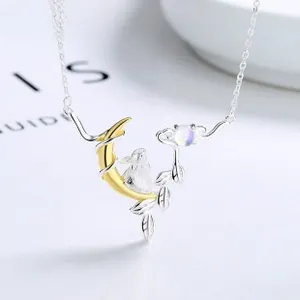 Macro shot of 925 sterling silver moonstone heart necklace with gold moon and rabbit pendant