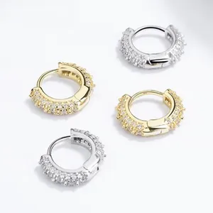 Detailed macro shot of 925 silver huggie hoop earrings with pave cubic zirconia stones