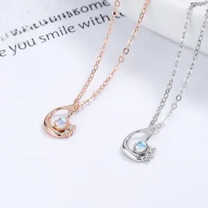Detailed view of silver and rose gold planet bracelets with luminous moonstones