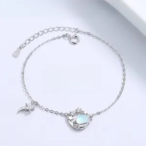 Macro detail of S925 silver planet bracelet with blue bead and shooting star charm