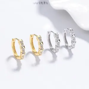 Detailed close-up of s925 silver hoop earrings with vertical rows of four clear crystals