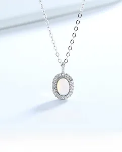 Detailed view of an oval moonstone pendant with sparkling halo set in S925 sterling silver