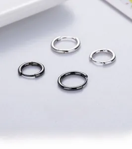 Detailed macro view of solid S925 sterling silver hoop earrings in silver and gun black