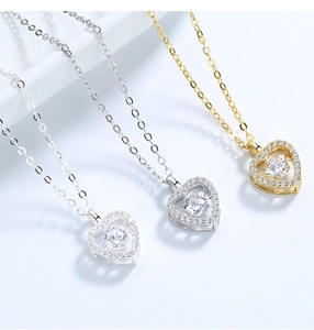 Detailed view of S925 sterling silver dancing heart pendants in gold and silver finishes