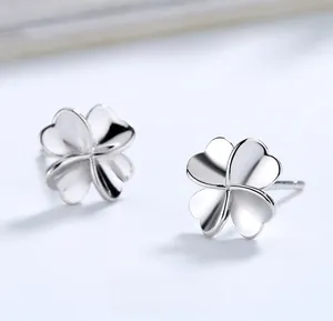 Detailed macro view of polished S925 sterling silver four-leaf clover stud earrings