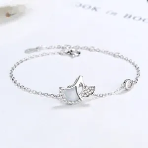 Detail of 925 silver ginkgo leaf bracelet with white mother-of-pearl and zirconia inlay