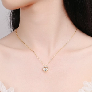 Elegant gold S925 silver heart necklace with a sparkling center stone on a female neck