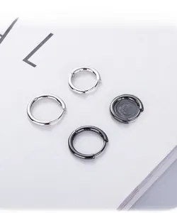 Detail showing S925 sterling silver hallmarks on silver and black hoop earrings