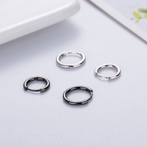 Close-up of four S925 sterling silver hoop earrings showing smooth finish and hallmarked logo