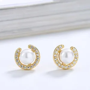 Macro shot of S925 sterling silver V-shape pearl stud earrings with sparkling pave diamonds