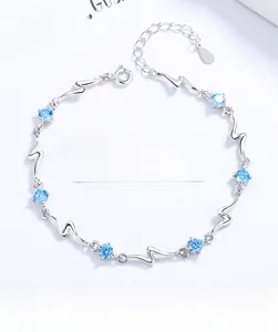 Macro view of S925 sterling silver bracelet with seven round light blue ocean crystals
