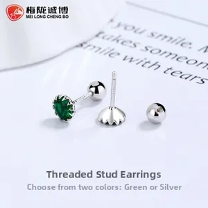 Macro detail of S925 sterling silver threaded stud earrings with emerald green gemstones