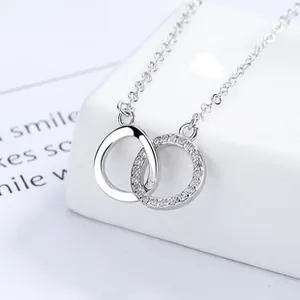 Detail of interlocking Möbius rings pendant with sparkling pavé cubic zirconia