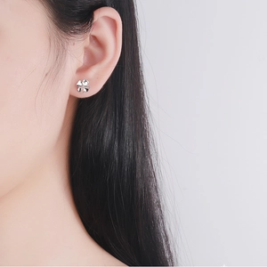 Elegant S925 sterling silver four-leaf clover stud earring worn by a model in a close-up view