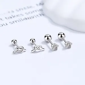 Detail of 925 sterling silver flower and knot stud earrings with secure screw back closure