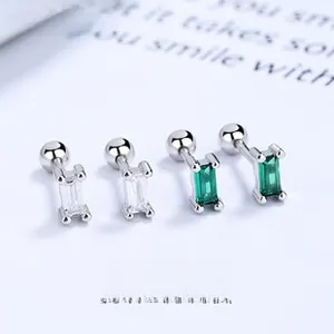Detailed view of rectangular stud earrings with white and emerald green zircon stones