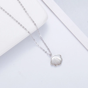 Macro detail of the white mother-of-pearl shell pendant on a 925 sterling silver chain